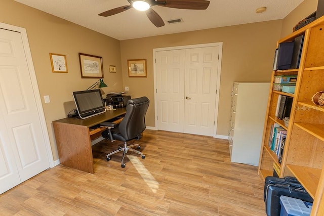 office with ceiling fan and light hardwood / wood-style flooring