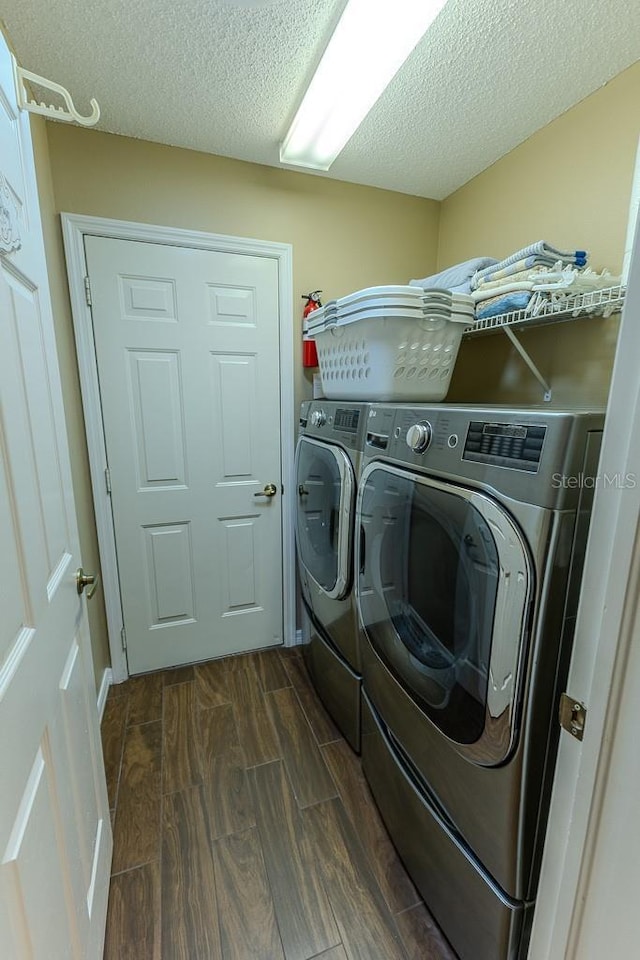 laundry area with a textured ceiling and independent washer and dryer