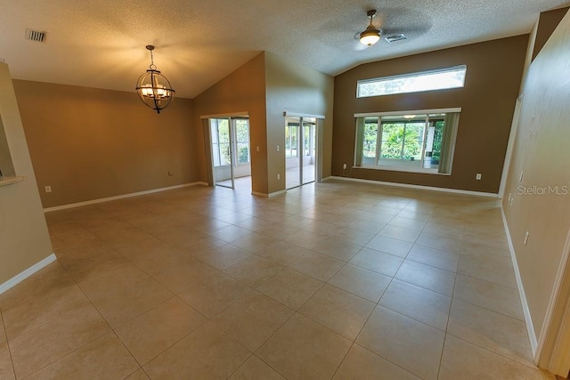 1604 Boswell Ln, New Port Richey, FL 34655 - unfurnished room with lofted ceiling, a chandelier, light tile patterned floors, a textured ceiling, and baseboards