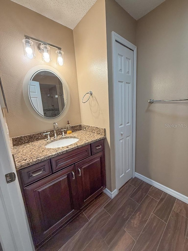 1604 Boswell Ln, New Port Richey, FL 34655 - bathroom featuring vanity, baseboards, and wood tiled floors