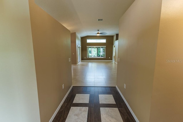 1604 Boswell Ln, New Port Richey, FL 34655 - corridor with wood finished floors, baseboards, and vaulted ceiling