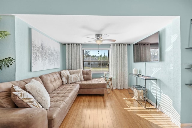 living room featuring ceiling fan and hardwood / wood-style floors