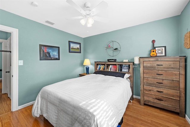 bedroom with ceiling fan and light hardwood / wood-style flooring