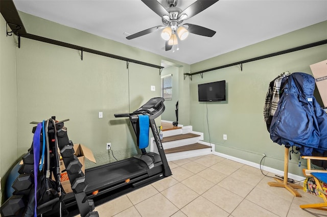 workout area with light tile patterned flooring and ceiling fan