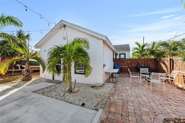 view of side of property with a patio area