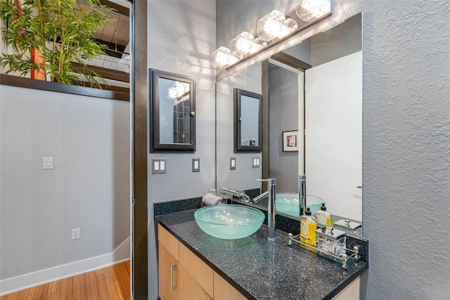 bathroom with hardwood / wood-style floors and vanity