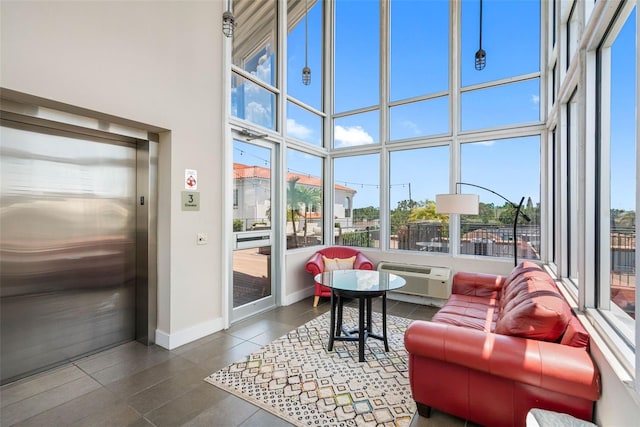 sunroom with elevator and an AC wall unit