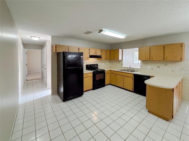 kitchen with sink, a textured ceiling, light tile patterned floors, kitchen peninsula, and black appliances