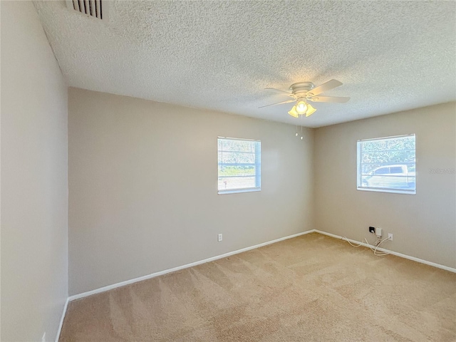 carpeted spare room with ceiling fan