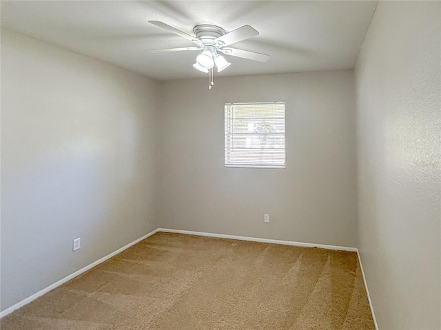 spare room featuring ceiling fan and carpet