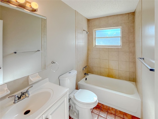 full bathroom with a textured ceiling, tiled shower / bath, tile patterned flooring, toilet, and vanity