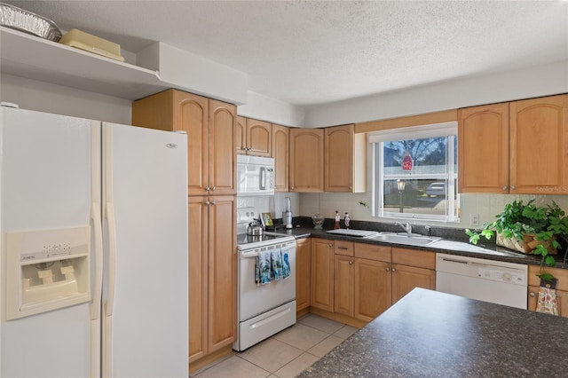 kitchen featuring sink, backsplash, light tile patterned floors, white appliances, and a textured ceiling