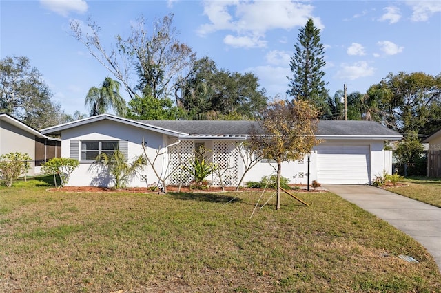 single story home featuring a garage and a front lawn