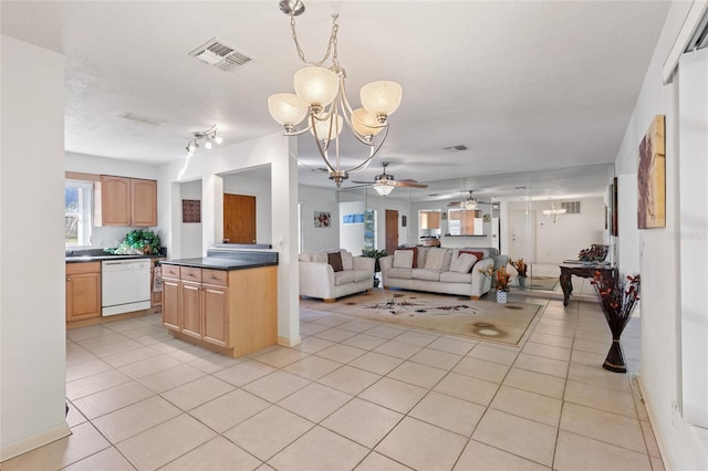 kitchen with pendant lighting, white dishwasher, light tile patterned flooring, light brown cabinetry, and ceiling fan with notable chandelier