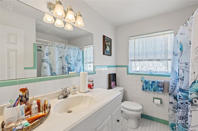 bathroom with toilet, tile patterned flooring, tile walls, and a wealth of natural light