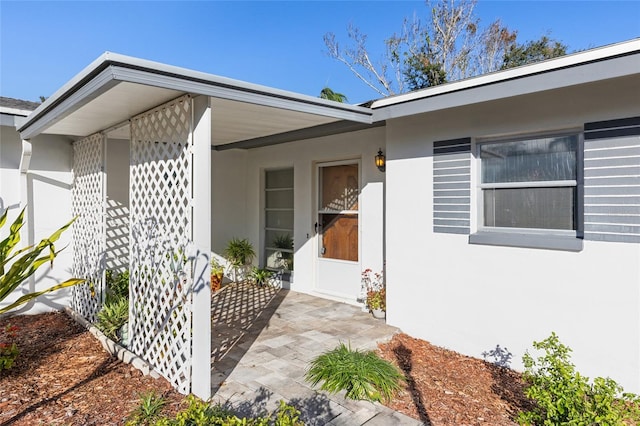 property entrance featuring a patio