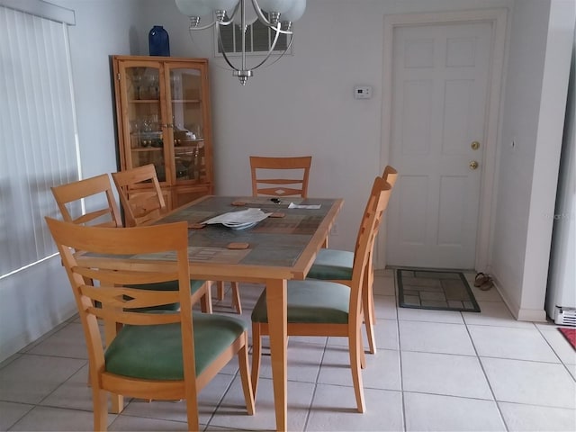 tiled dining space featuring a notable chandelier