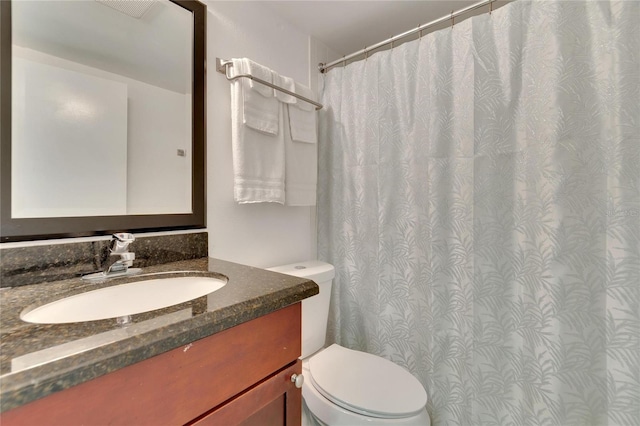 bathroom with toilet and vanity