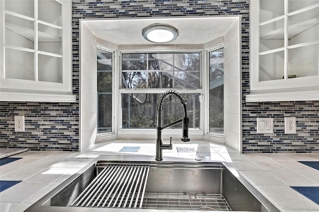 details featuring decorative backsplash and sink