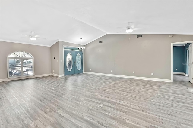 unfurnished living room with crown molding, lofted ceiling, ceiling fan with notable chandelier, and french doors