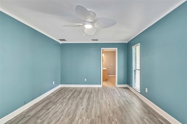 unfurnished room with ceiling fan, crown molding, and light hardwood / wood-style floors