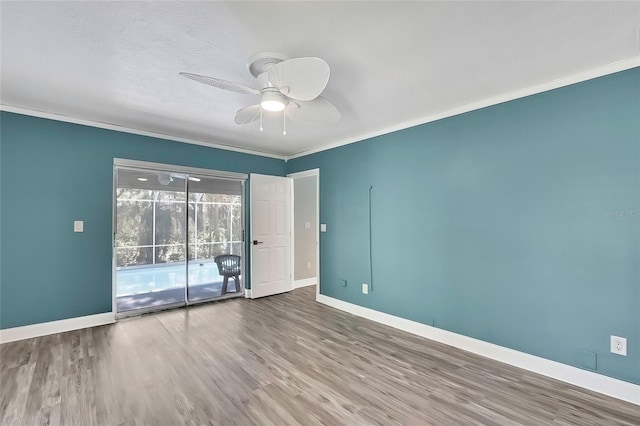 empty room featuring ceiling fan, wood-type flooring, and ornamental molding