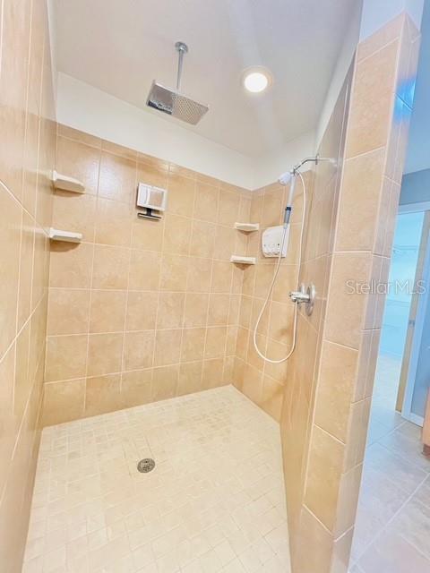 bathroom featuring tile patterned floors and tiled shower