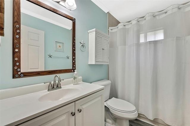 bathroom with toilet, ornamental molding, hardwood / wood-style flooring, and vanity