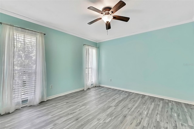 unfurnished room featuring ceiling fan, crown molding, and light hardwood / wood-style flooring