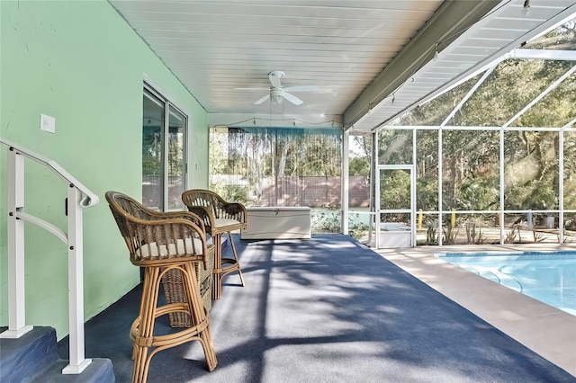 sunroom with ceiling fan and a pool