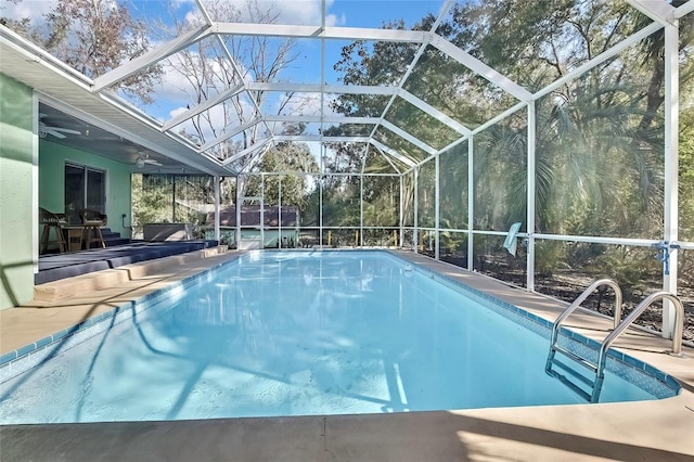 view of pool featuring ceiling fan, a patio area, and glass enclosure