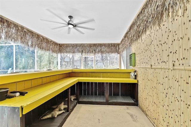 miscellaneous room featuring ceiling fan and concrete flooring