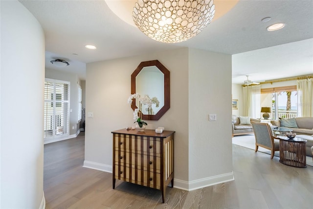 hallway with hardwood / wood-style floors