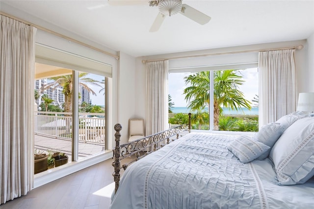 bedroom featuring hardwood / wood-style floors, access to exterior, and ceiling fan