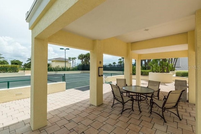 view of patio / terrace with tennis court