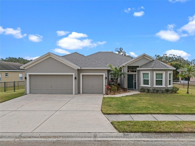 ranch-style house featuring a garage and a front yard