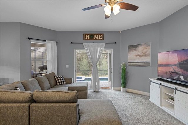 carpeted living room featuring ceiling fan