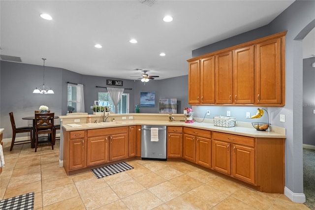 kitchen with dishwasher, kitchen peninsula, pendant lighting, sink, and ceiling fan with notable chandelier