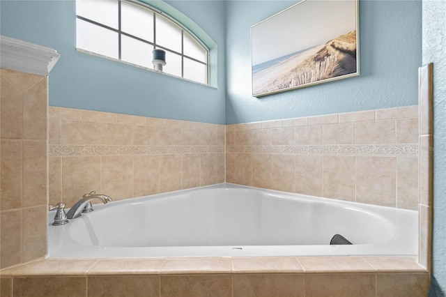 bathroom featuring tiled tub