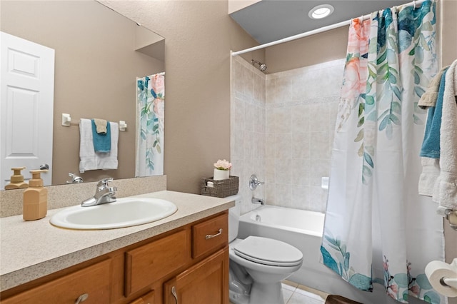 full bathroom featuring tile patterned floors, shower / bath combo with shower curtain, vanity, and toilet