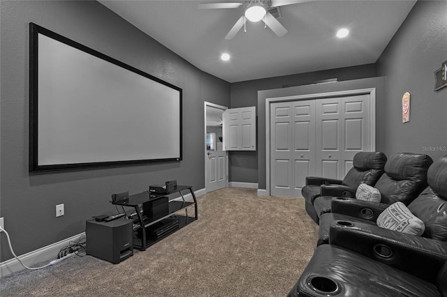 cinema with ceiling fan and carpet flooring