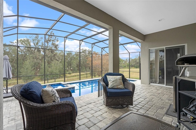 view of patio / terrace featuring a lanai and a pool with hot tub