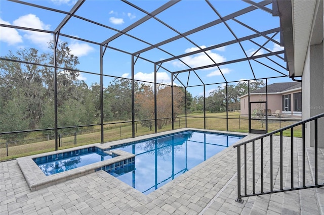 view of pool with a lanai, a patio, a yard, and an in ground hot tub