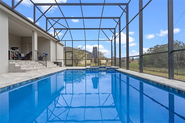 view of swimming pool featuring a patio, glass enclosure, and an in ground hot tub