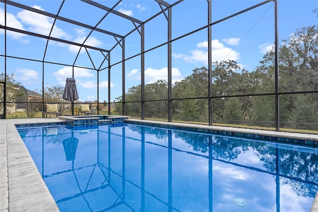 view of pool with a lanai and an in ground hot tub