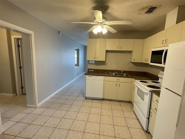 kitchen with white appliances, sink, light tile patterned floors, and tasteful backsplash