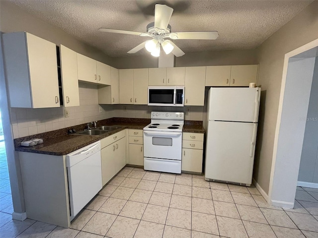 kitchen with white appliances, sink, ceiling fan, light tile patterned floors, and a textured ceiling