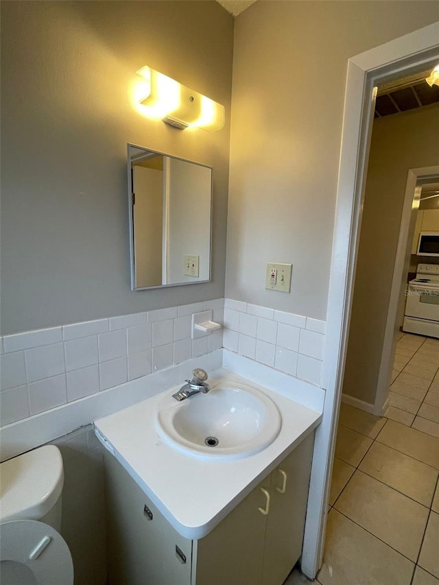 bathroom featuring tile patterned floors, vanity, and toilet