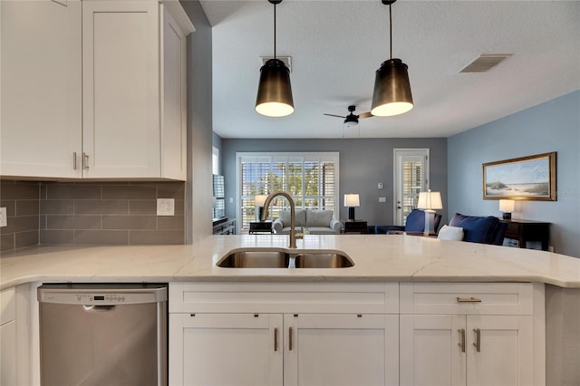 kitchen featuring dishwasher, sink, and white cabinetry