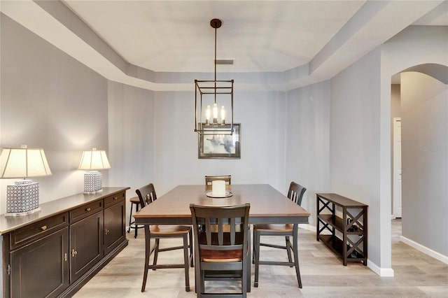 dining space with a chandelier and light hardwood / wood-style floors